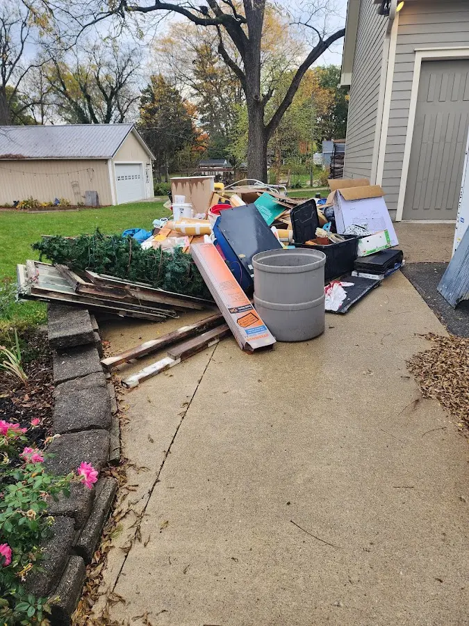 Dumpster being loaded with debris for Roofing Dumpster Rental in Clayton